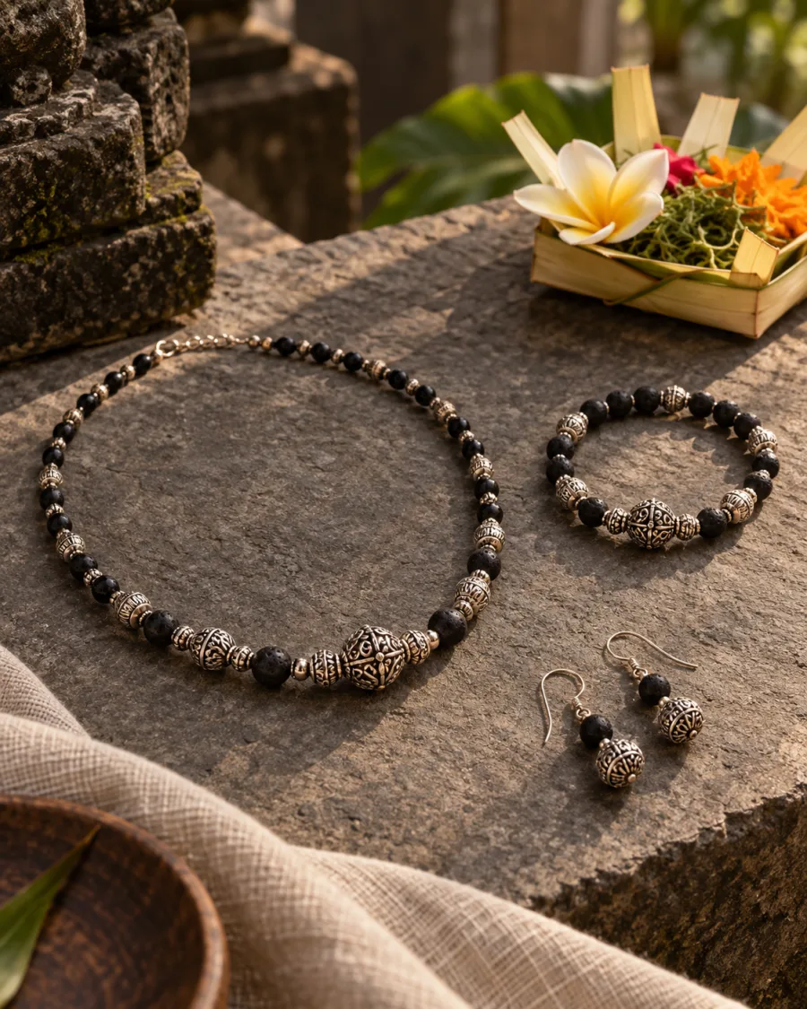 Coordinated necklace, bracelet and earrings beside a Balinese offering