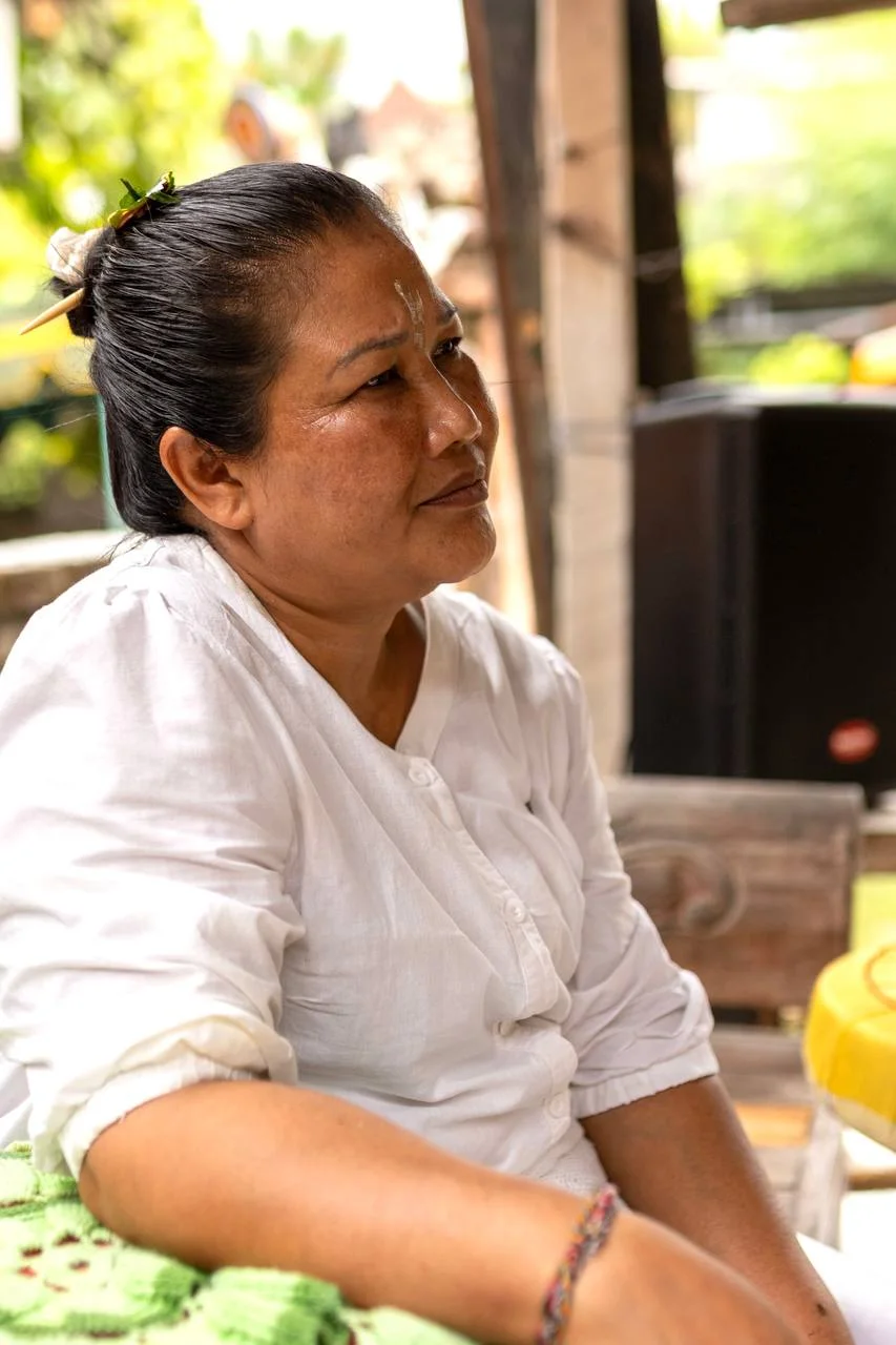 Portrait of Ibu Jero in white ceremonial clothing in Bali